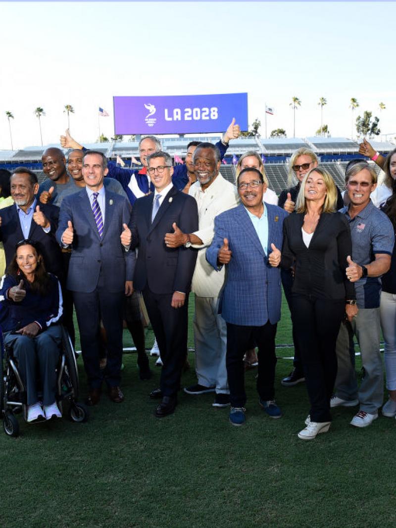 a group of people smiling in a stadium