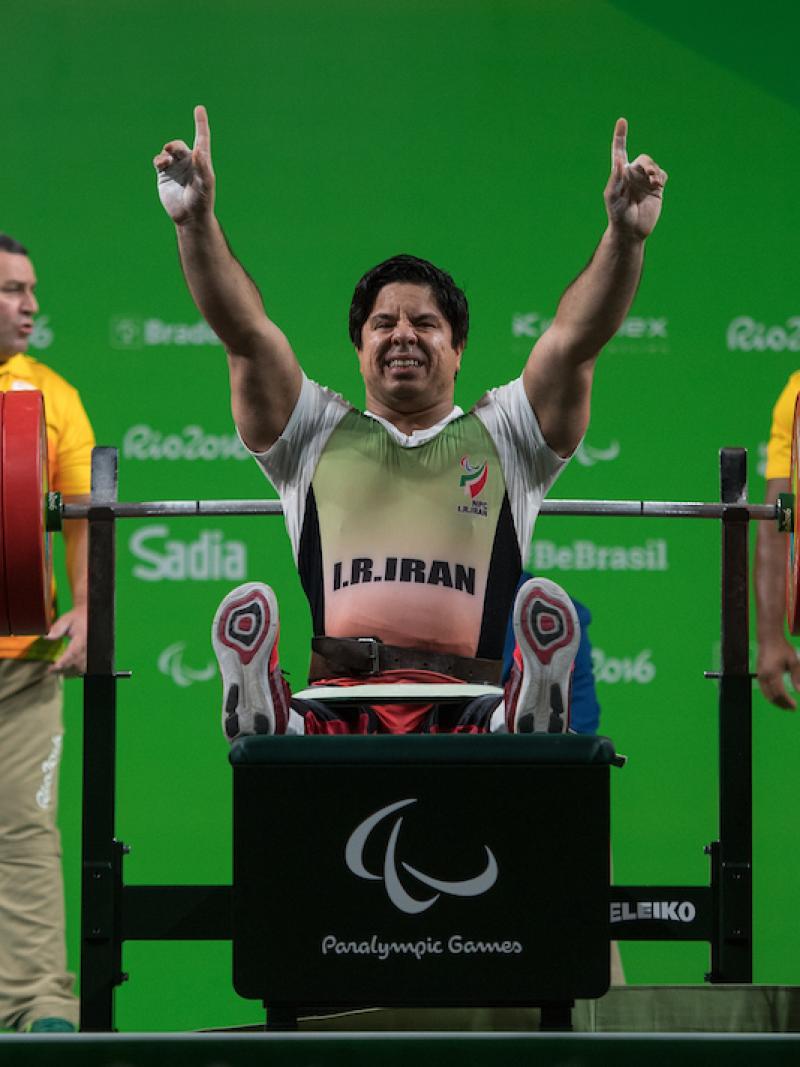 a Para powerlifter celebrates on the bench