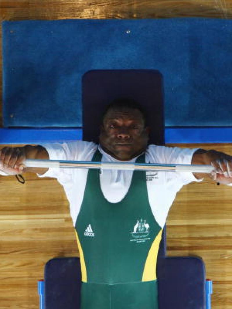 Male powerlifter lifts a bar