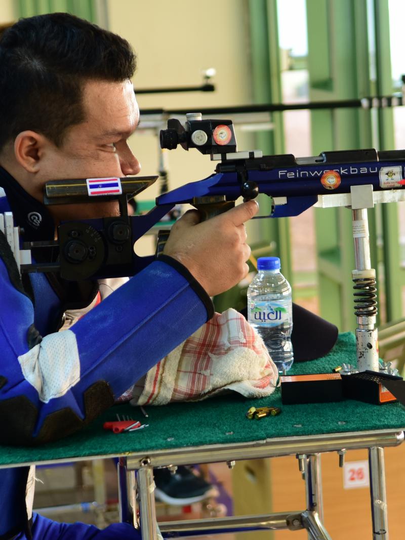 Man competing in R9 (mixed 50m rifle prone SH2) event 