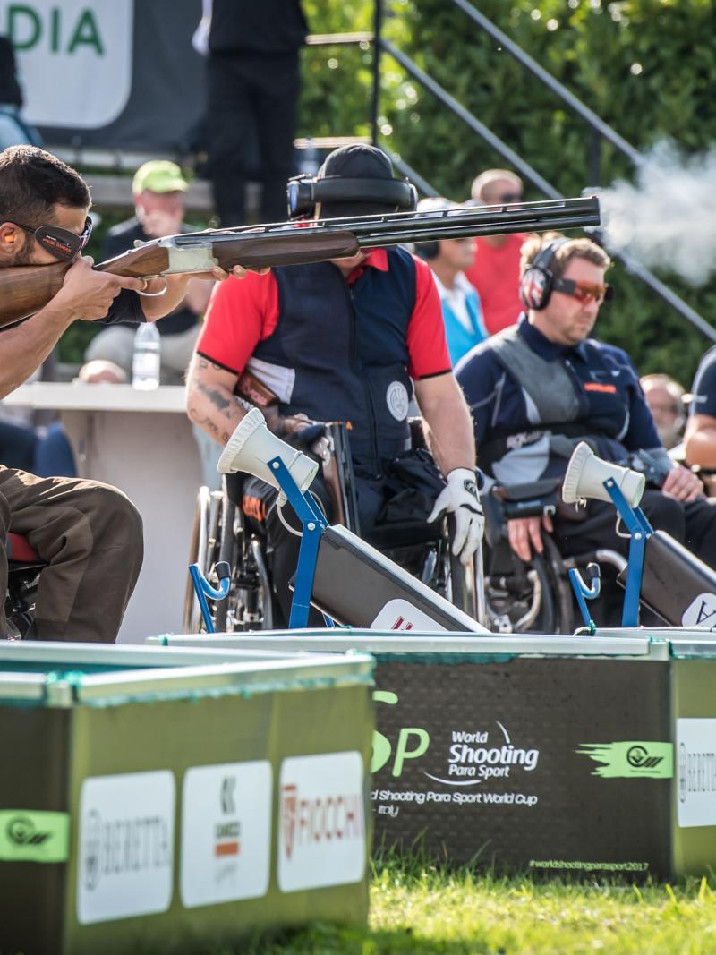 Man shoots a shotgun during a competition 