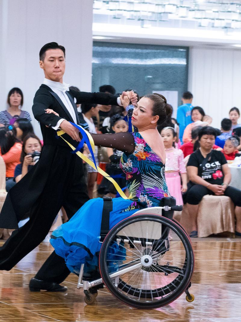 Woman in wheelchair dances with standing partner