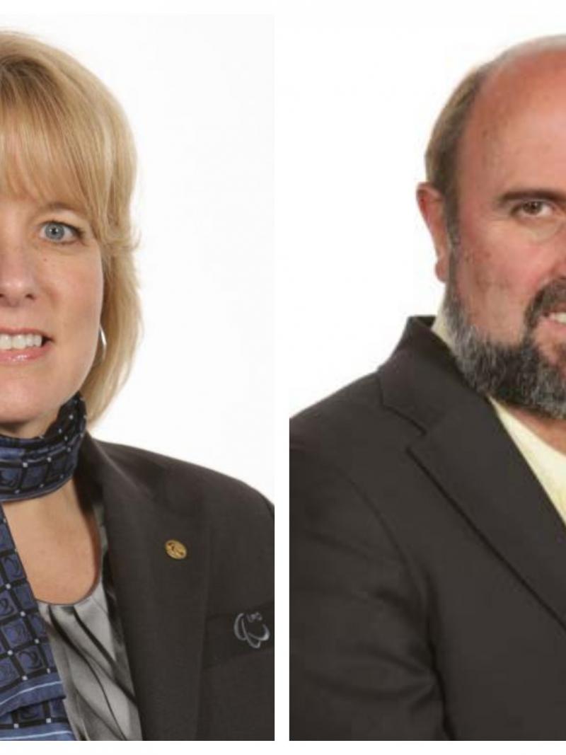 a female and a male smile for the camera