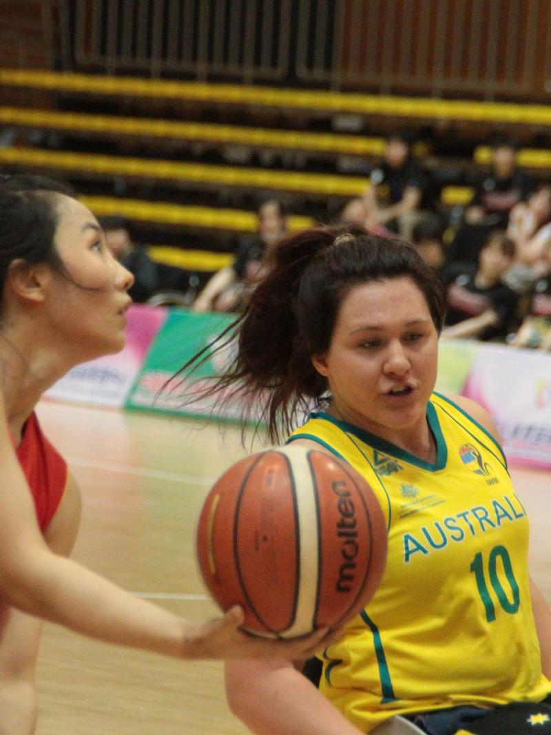 female wheelchair basketball players battle for the ball