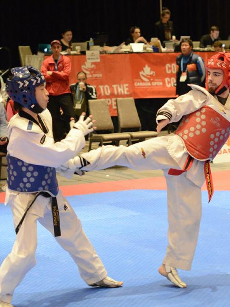 two Para taekwondo fighters on the mat