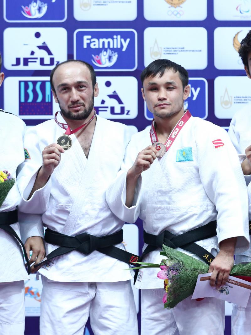 four Para judokas stand on the podium with their medals