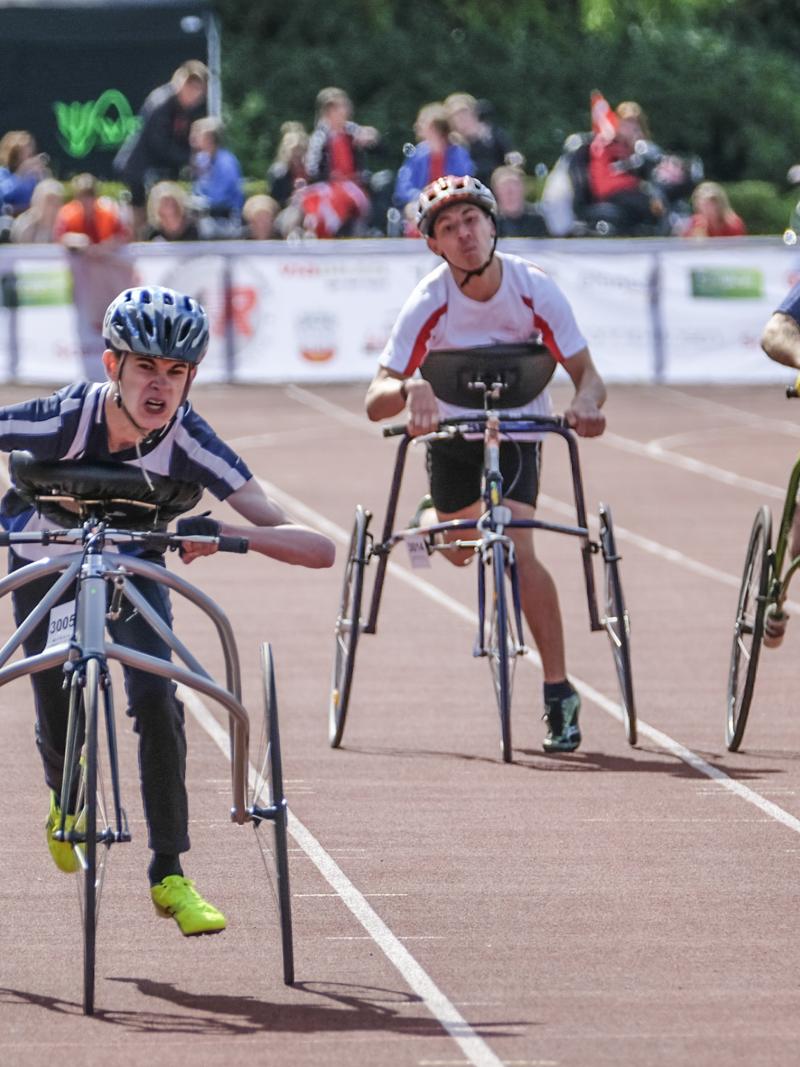 three RaceRunning athletes run down the track