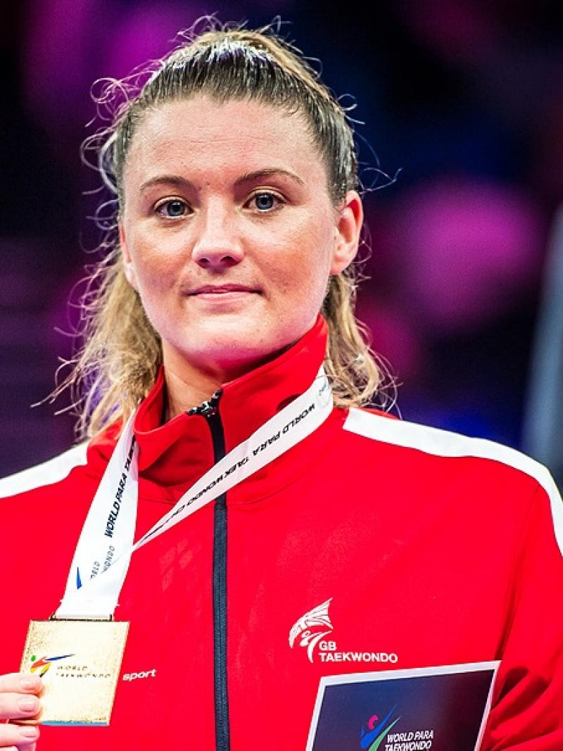 a female Para athlete with her gold medal