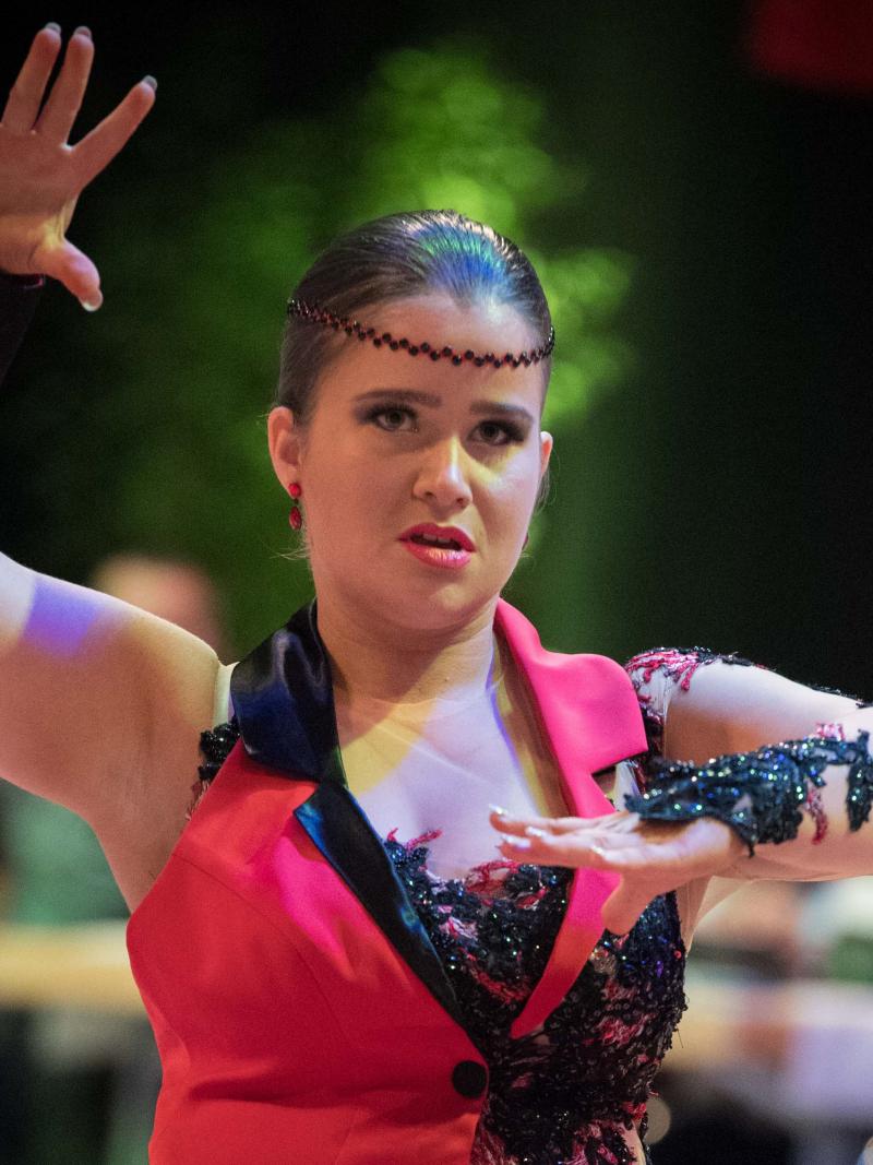 a female Para dance athlete shapes her arms