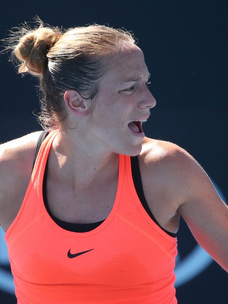 a female Para wheelchair tennis player gives a celebratory fist pump