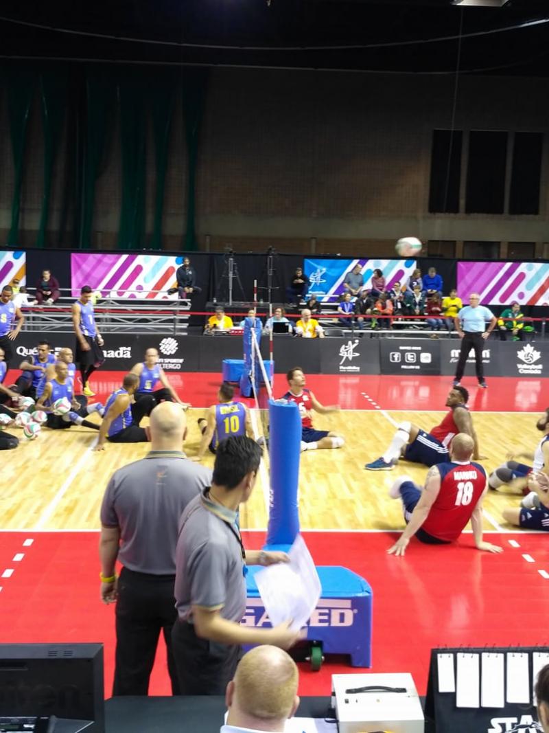 two sitting volleyball teams on the court ready to begin play
