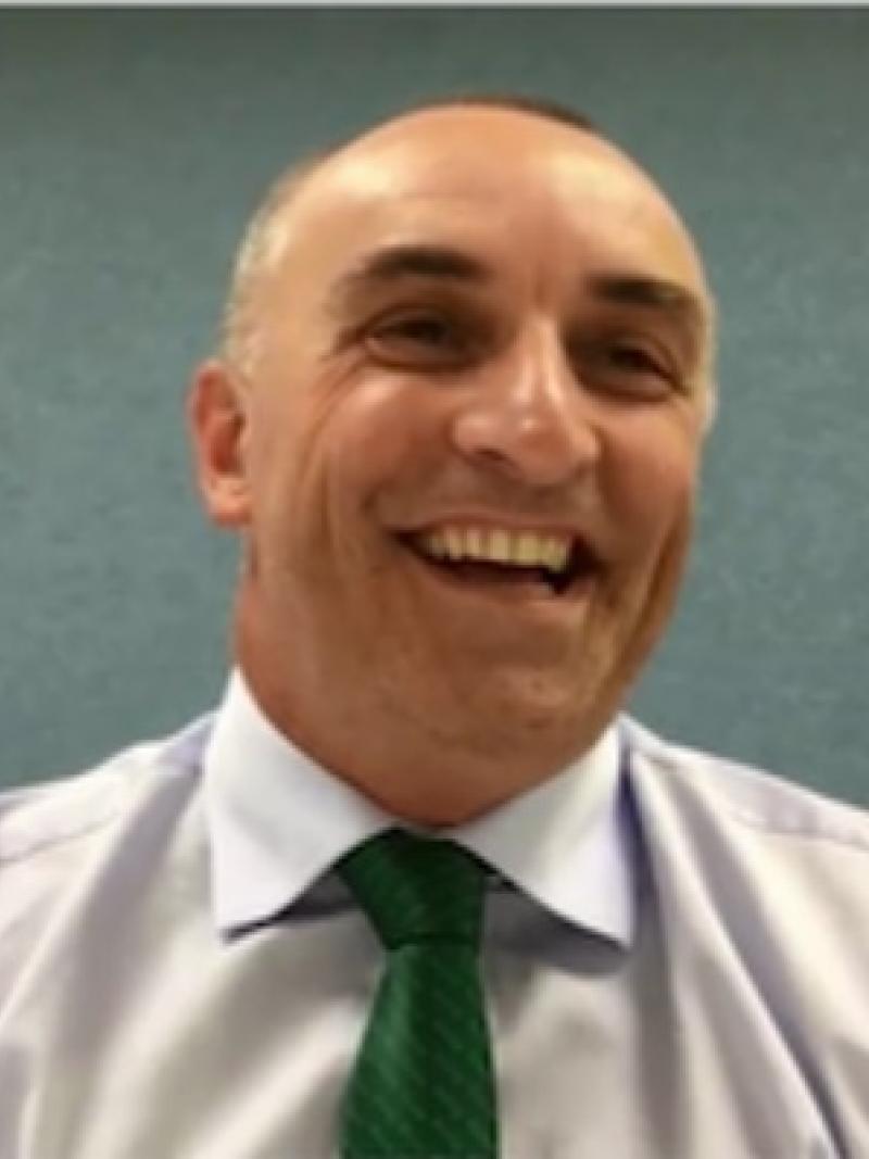 a man smiling at the camera