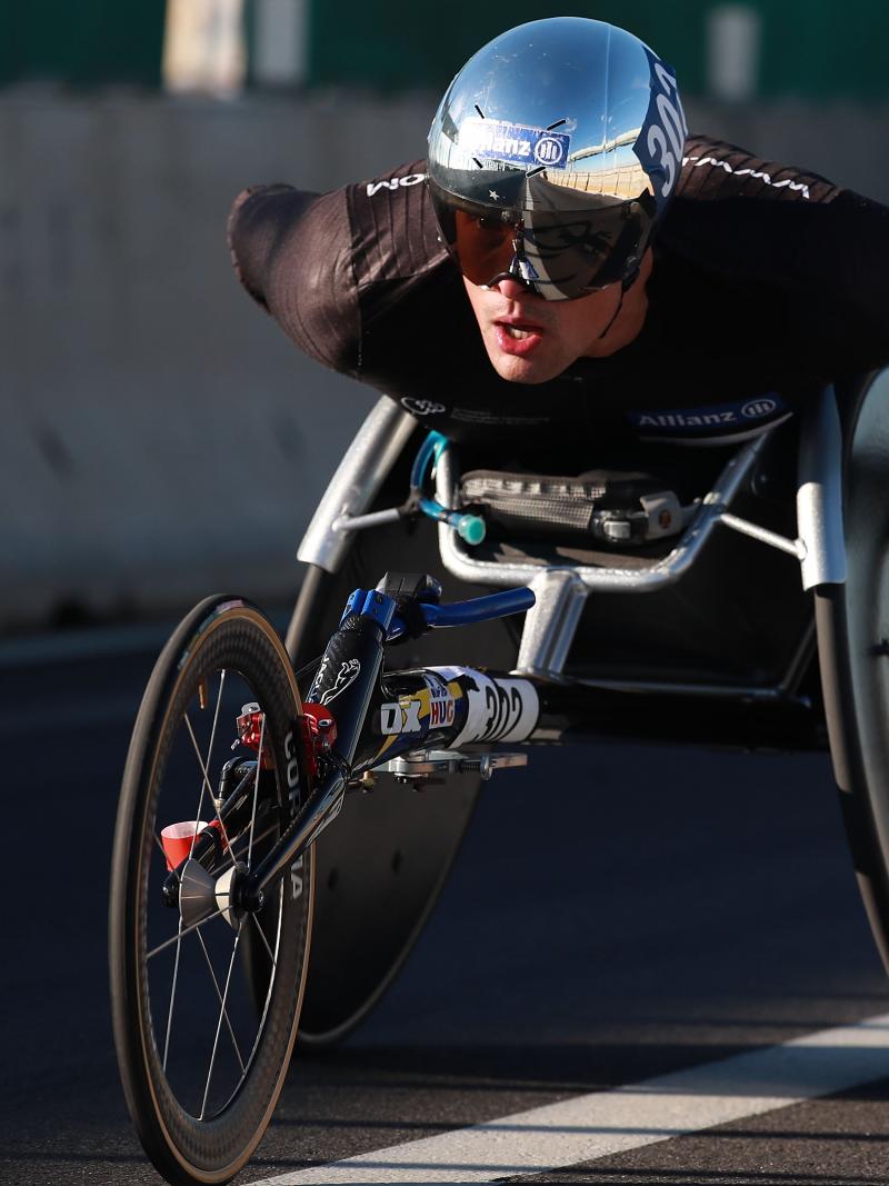 a male wheelchair racer on the road