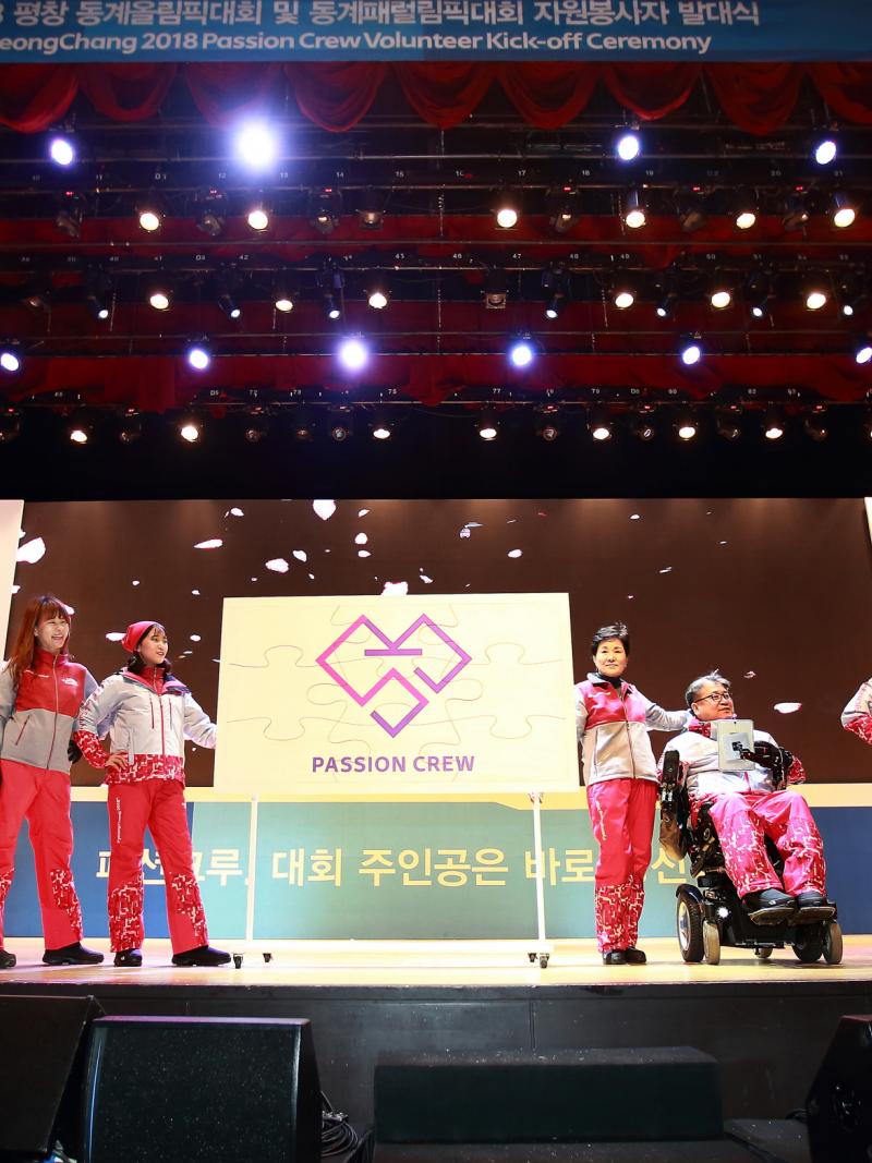 a group of people model outfits on a stage