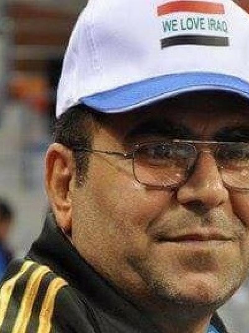 a man in a baseball cap smiles at the camera