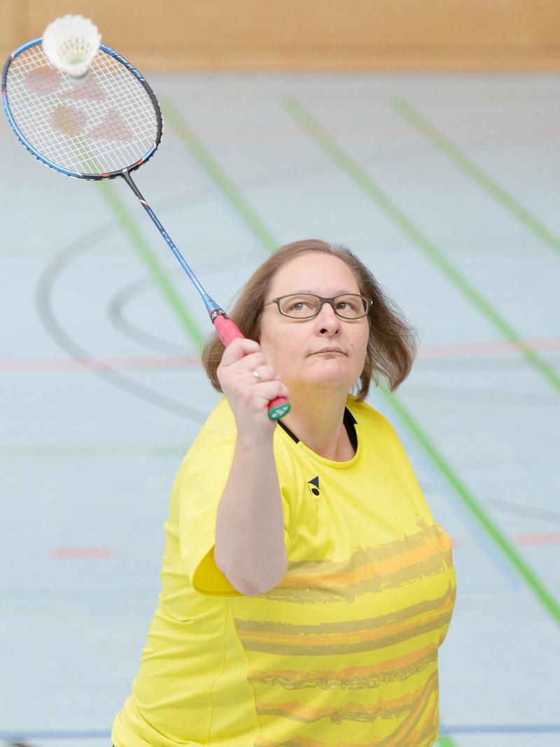 a female Para badminton player goes for a shot