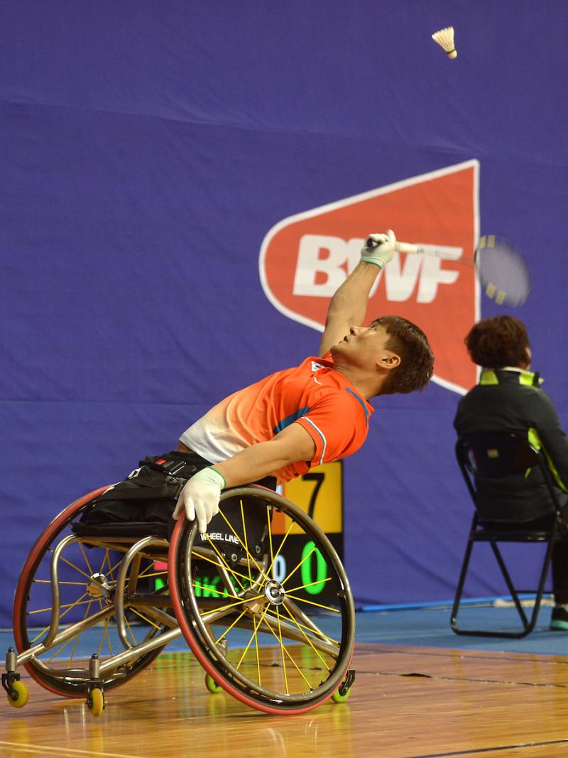 Man in wheelchair playing badminton