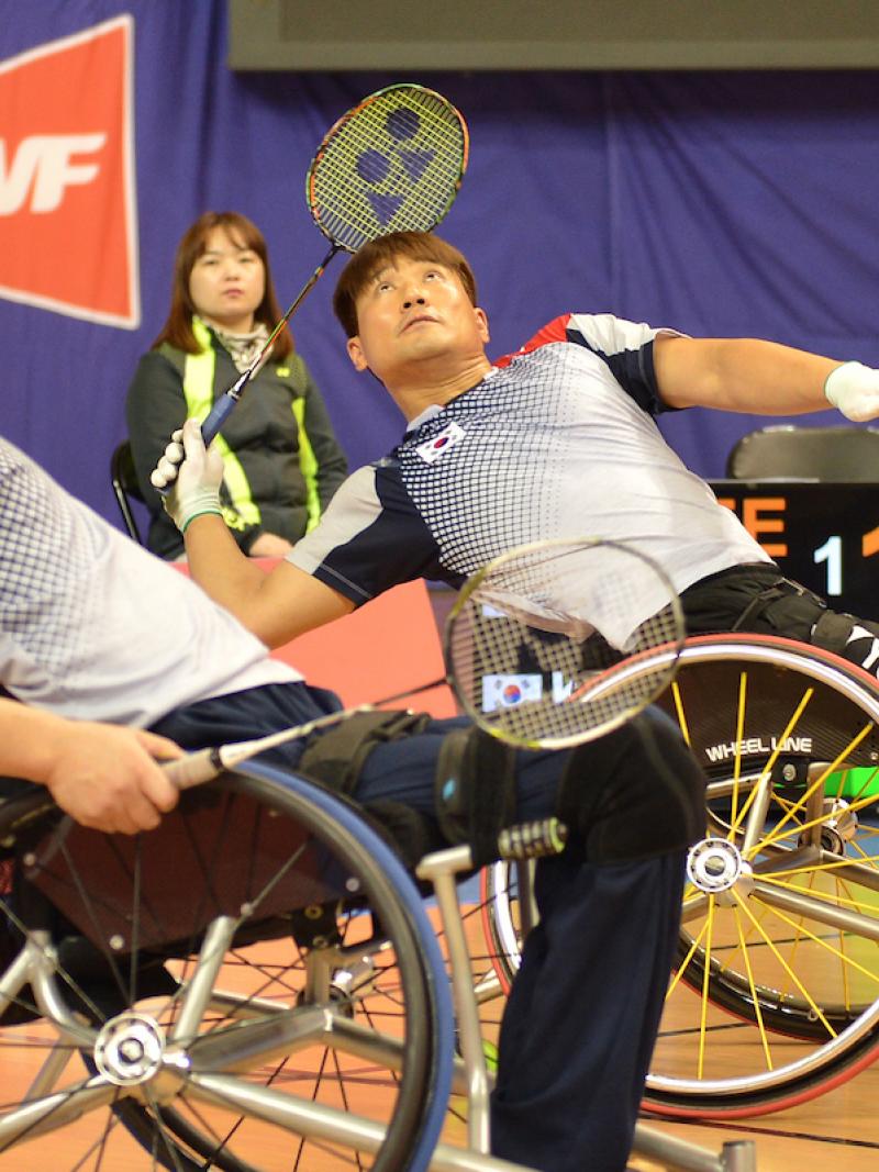 two male Para badminton players on the court