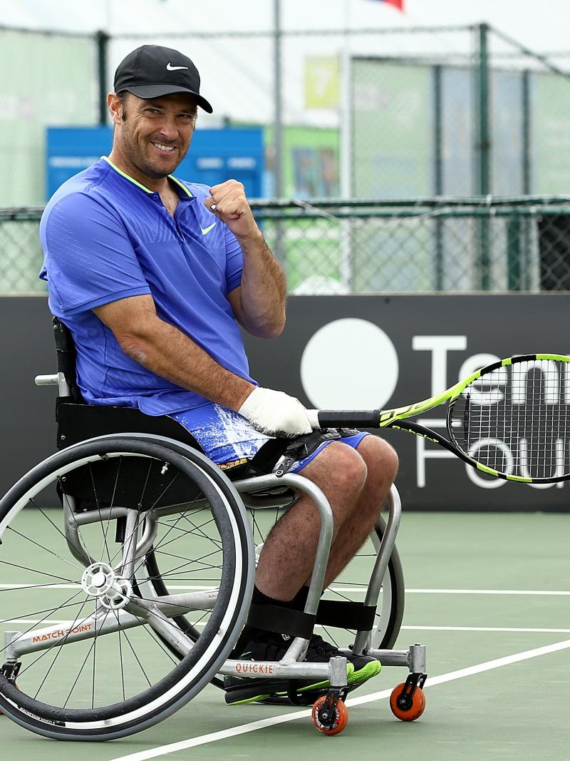 a male wheelchair tennis player gives a fist pump