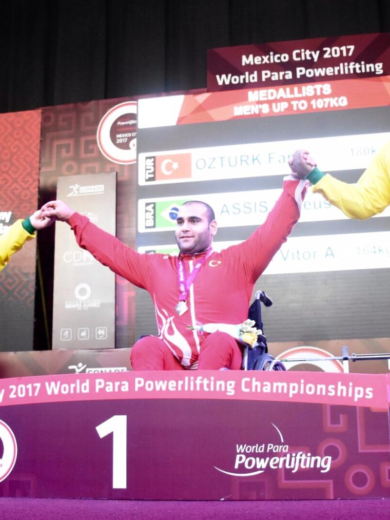 three male powerlifters on the podium