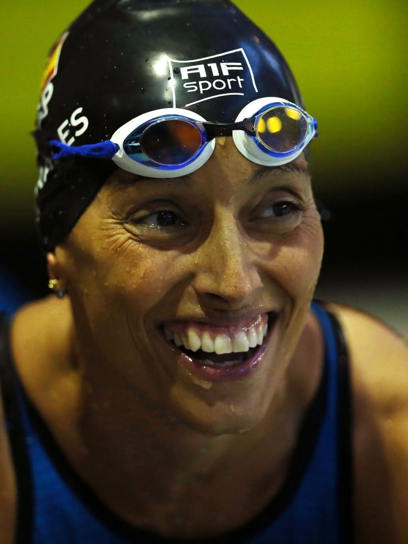 a female Para swimmer smiling in the pool