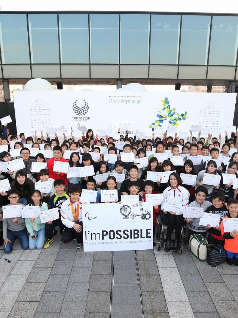 a group of schoolchildren holding up signs