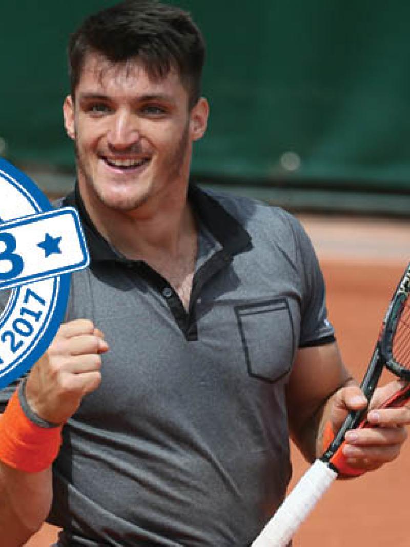 a male wheelchair tennis player celebrates winning a point