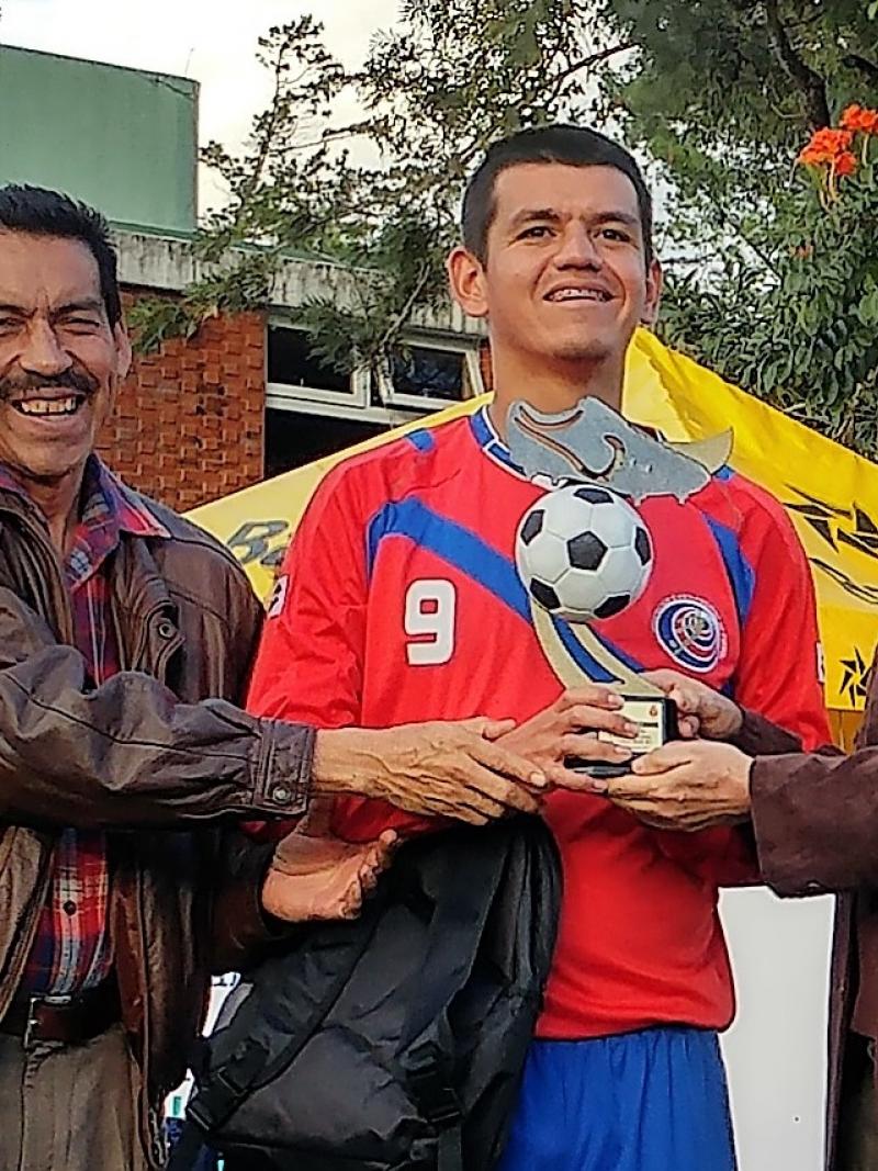 a blind footballer with his trophy