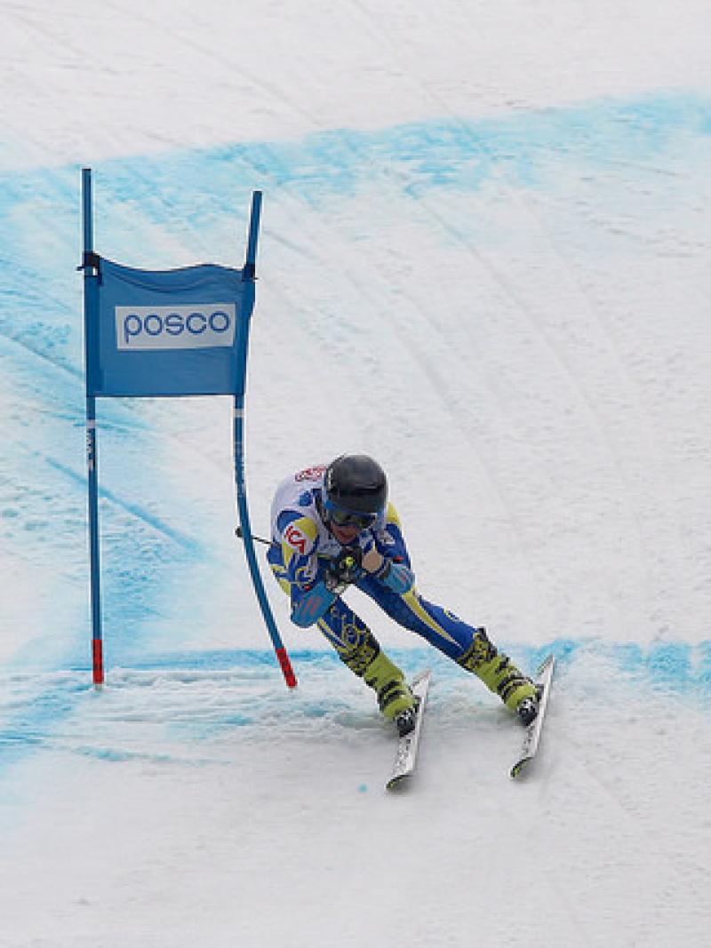Alpine skier skies down a hill