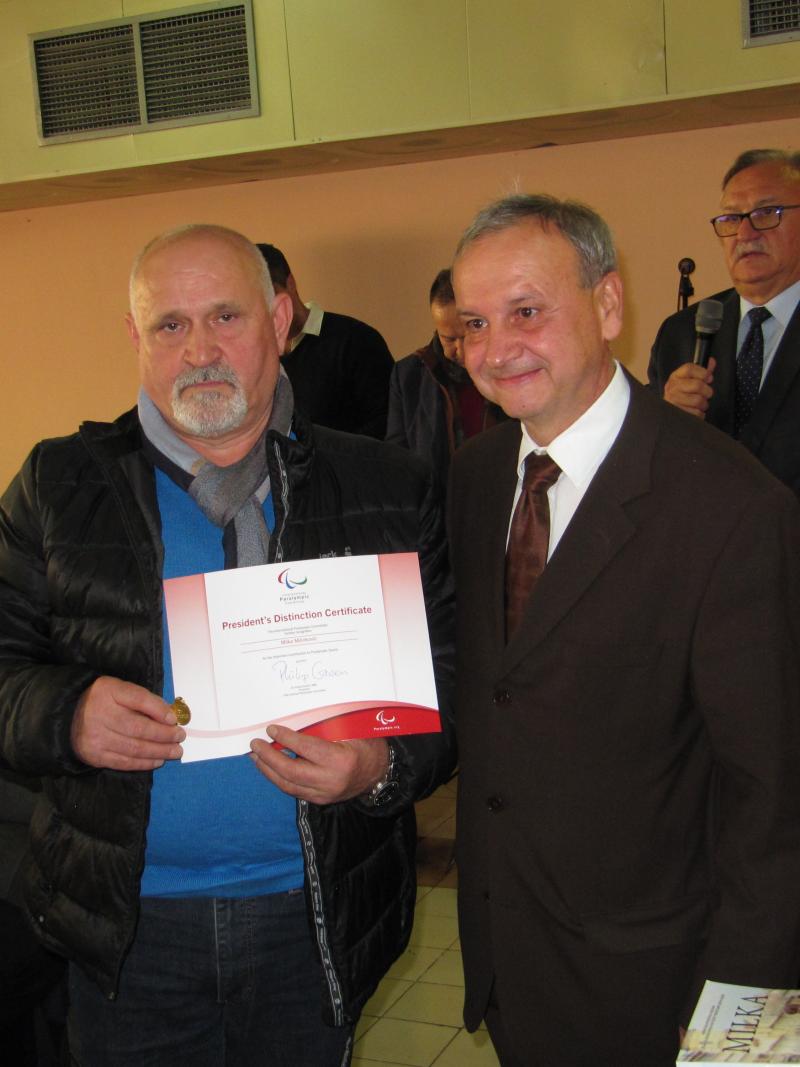 Two men holding up a certificate