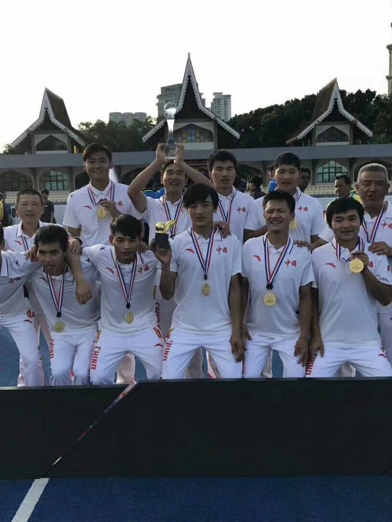 a group of blind footballers celebrate with their medals and trophies