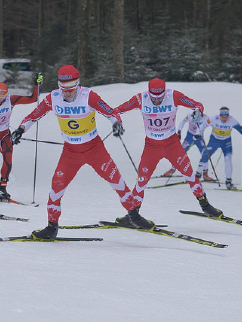 Two vision impaired cross-country skiers race with their guides