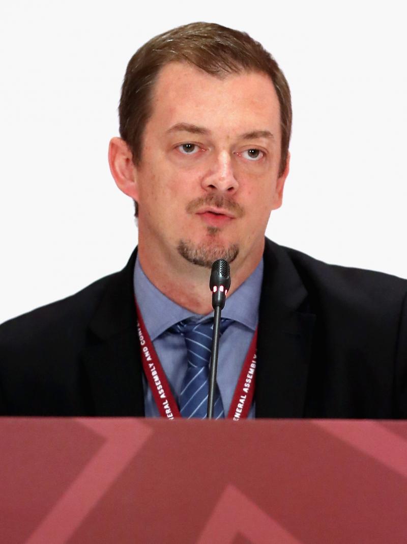 a man speaking at a desk
