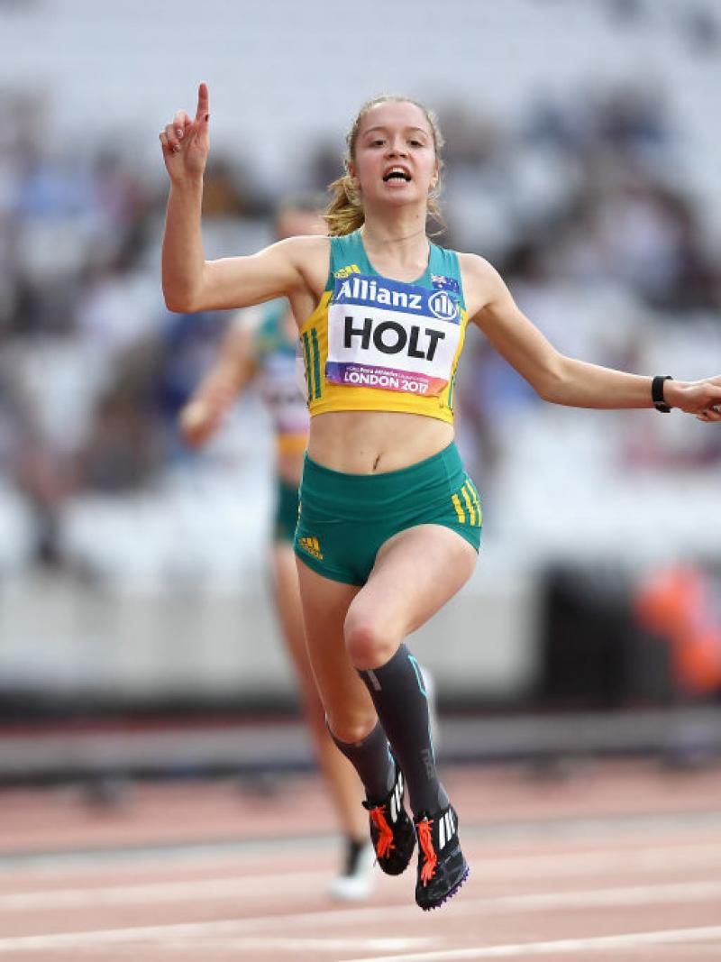 a female Para sprinter crosses the line to win the race