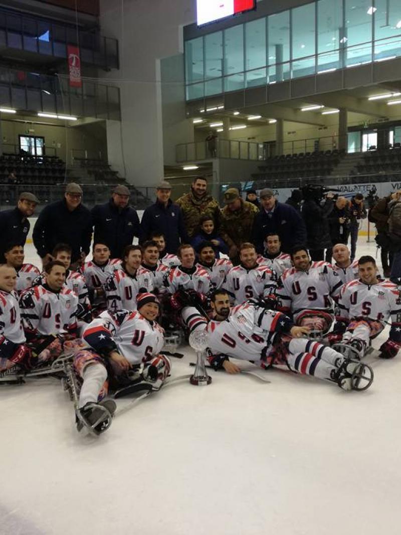 a Para ice hockey team sitting on the ice
