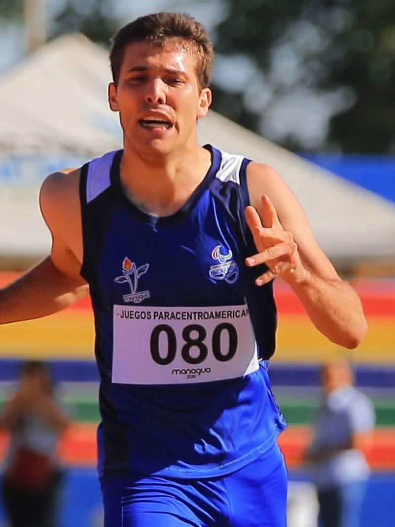 a male Para athlete crosses the finish line