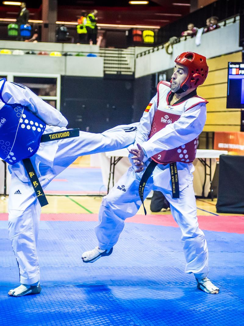 Two male taekwondo athletes fight