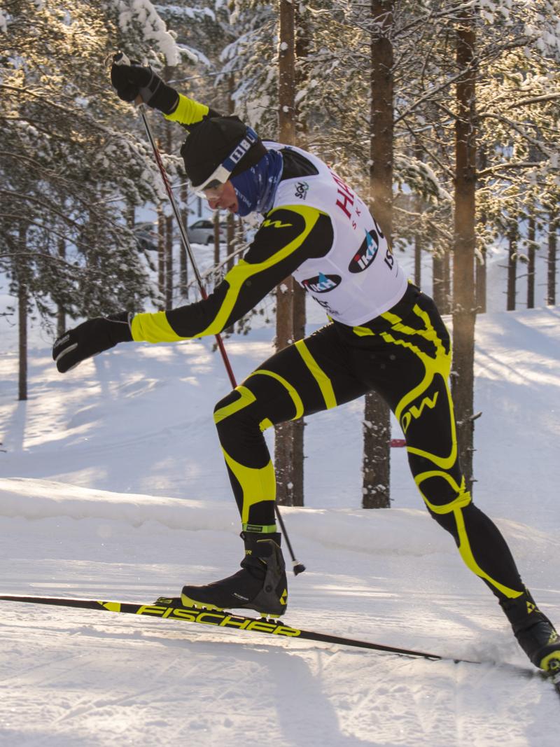 Male standing biathlete racing
