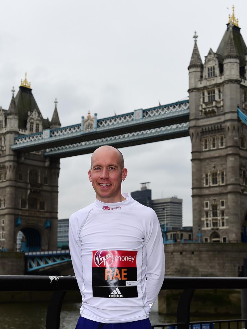 a man standing in front of London's Tower Bridge