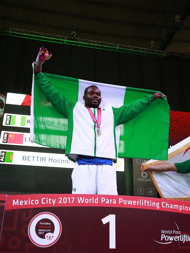 three male powerlifters on a podium
