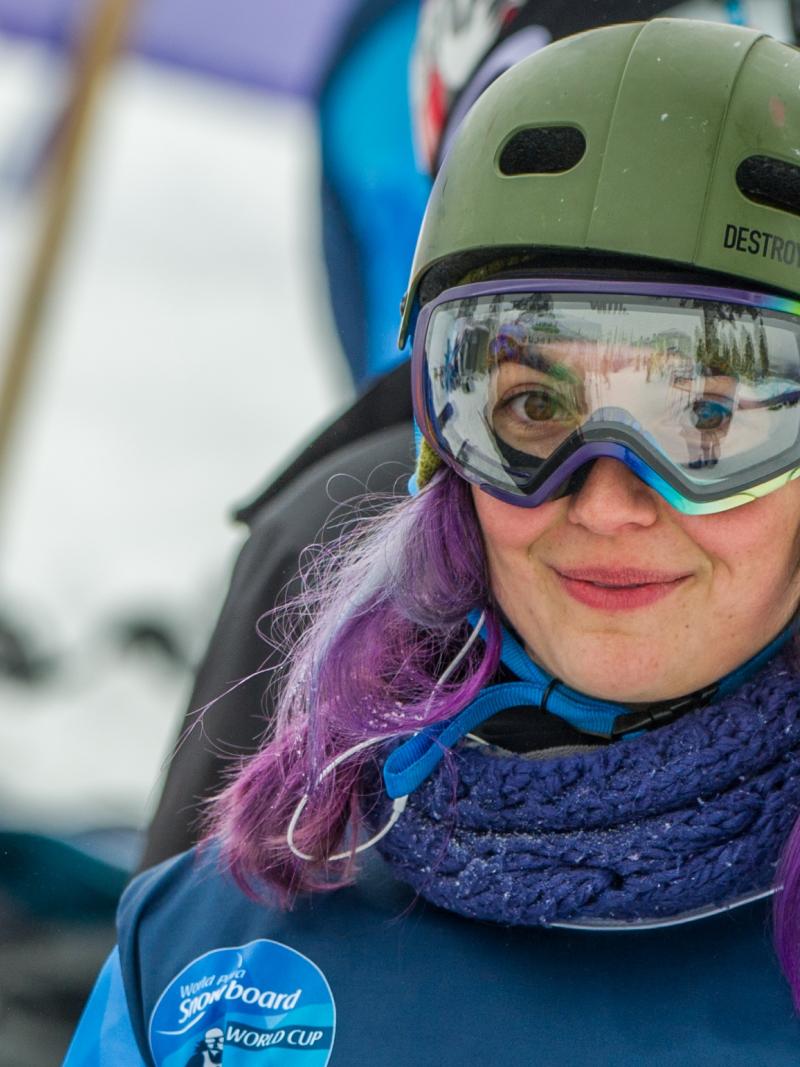 a female Para snowboarder smiles