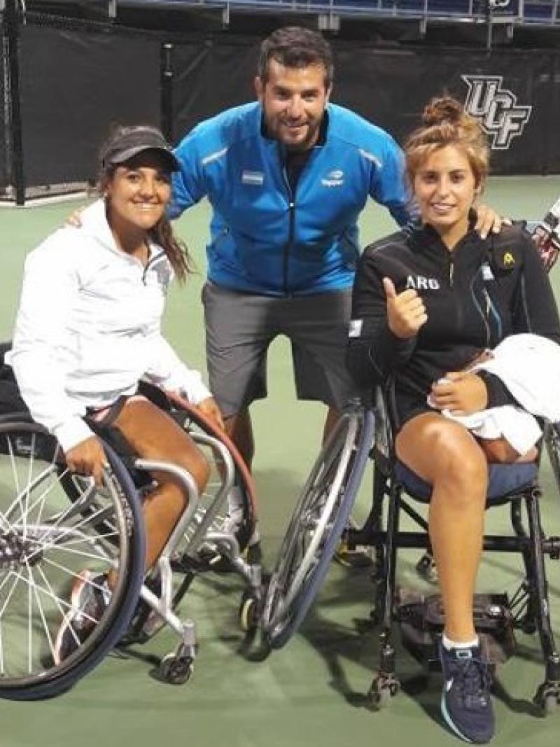 two female wheelchair tennis players with their coach
