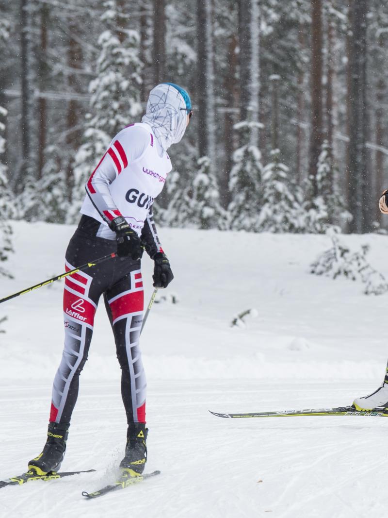 a female vision impaired skier and her guide