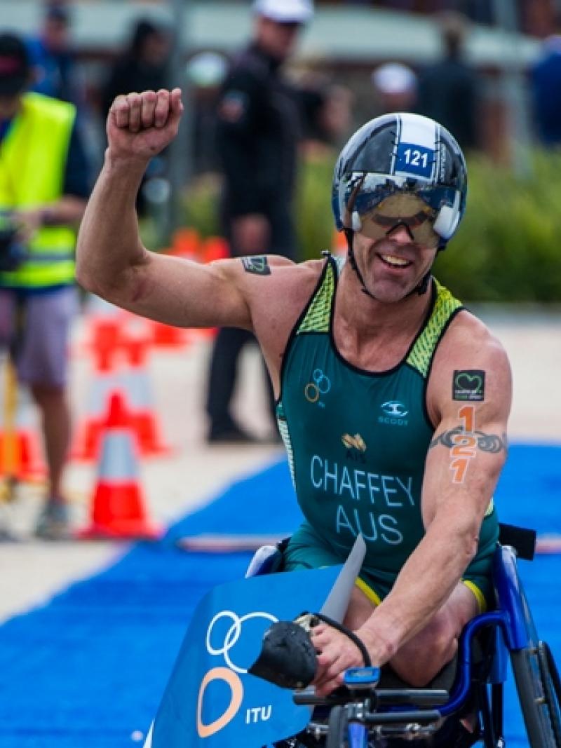 Triathlete celebrates crossing finishing line