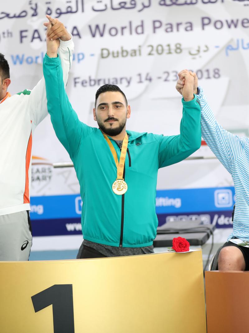 three male powerlifters on the podium