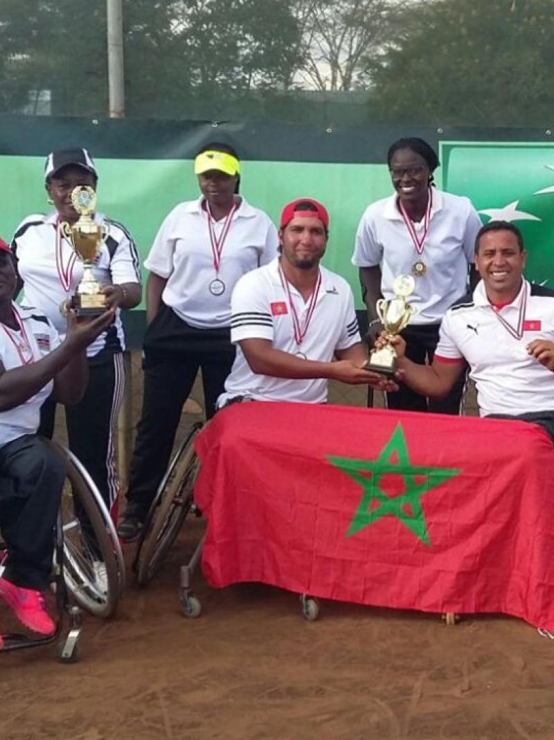 a group of wheelchair tennis players with their trophies