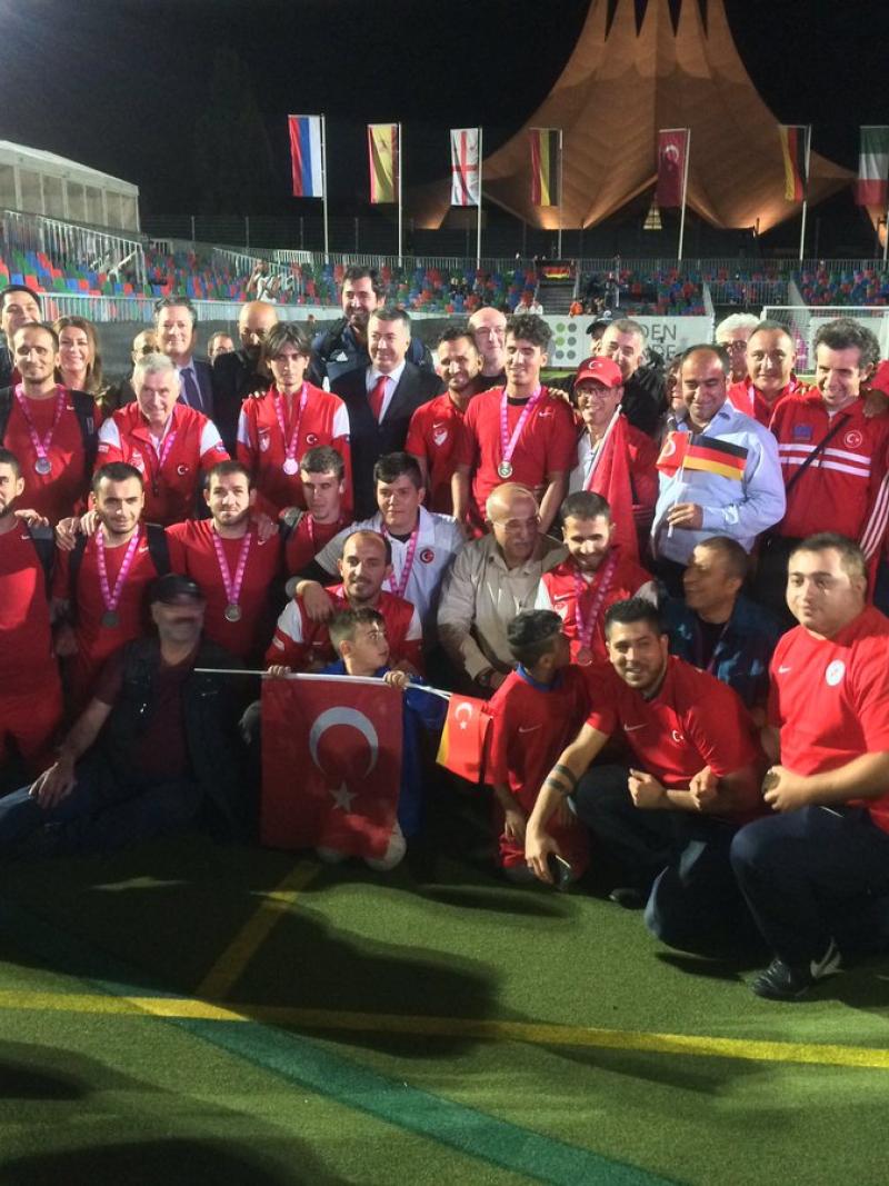 a group of blind footballers pose for a photo on the pitch