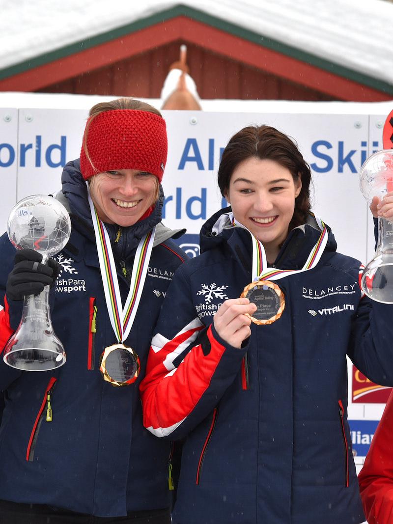 a female vision impaired skier and her guide on the podium