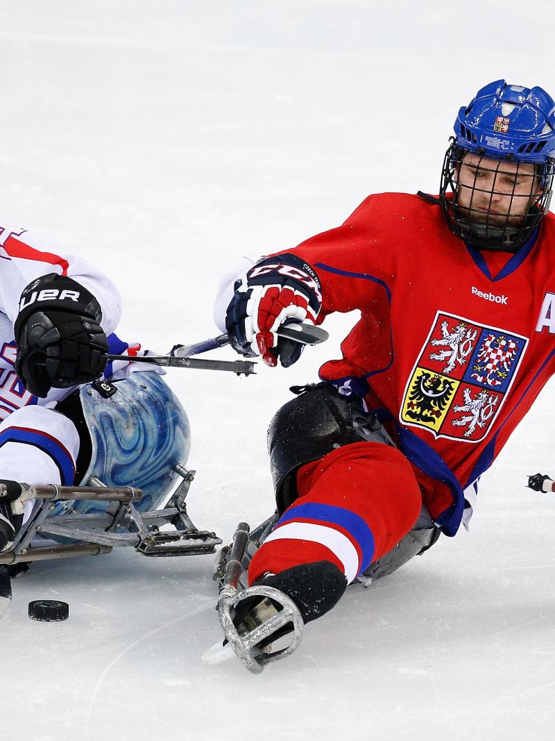 two Para ice hockey players clash on the ice