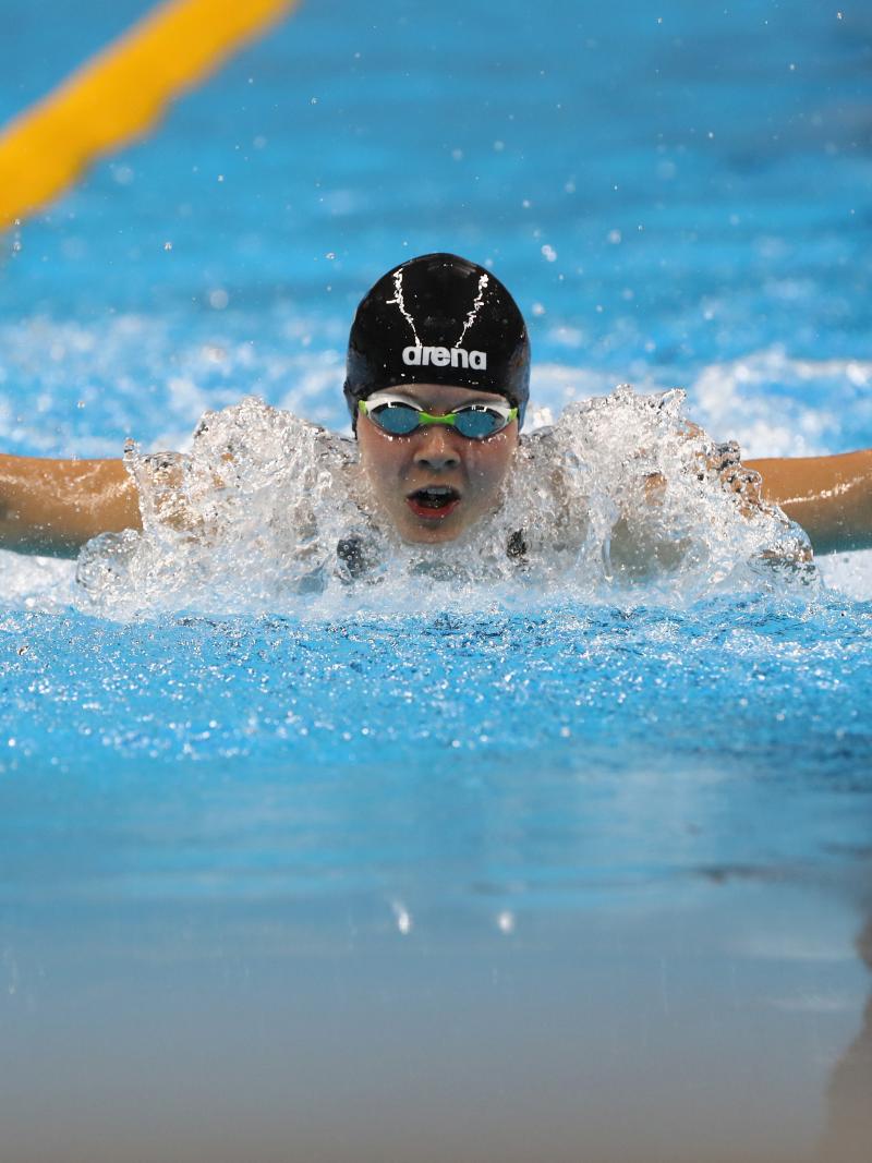 a female Para swimmer mid-butterfly stroke